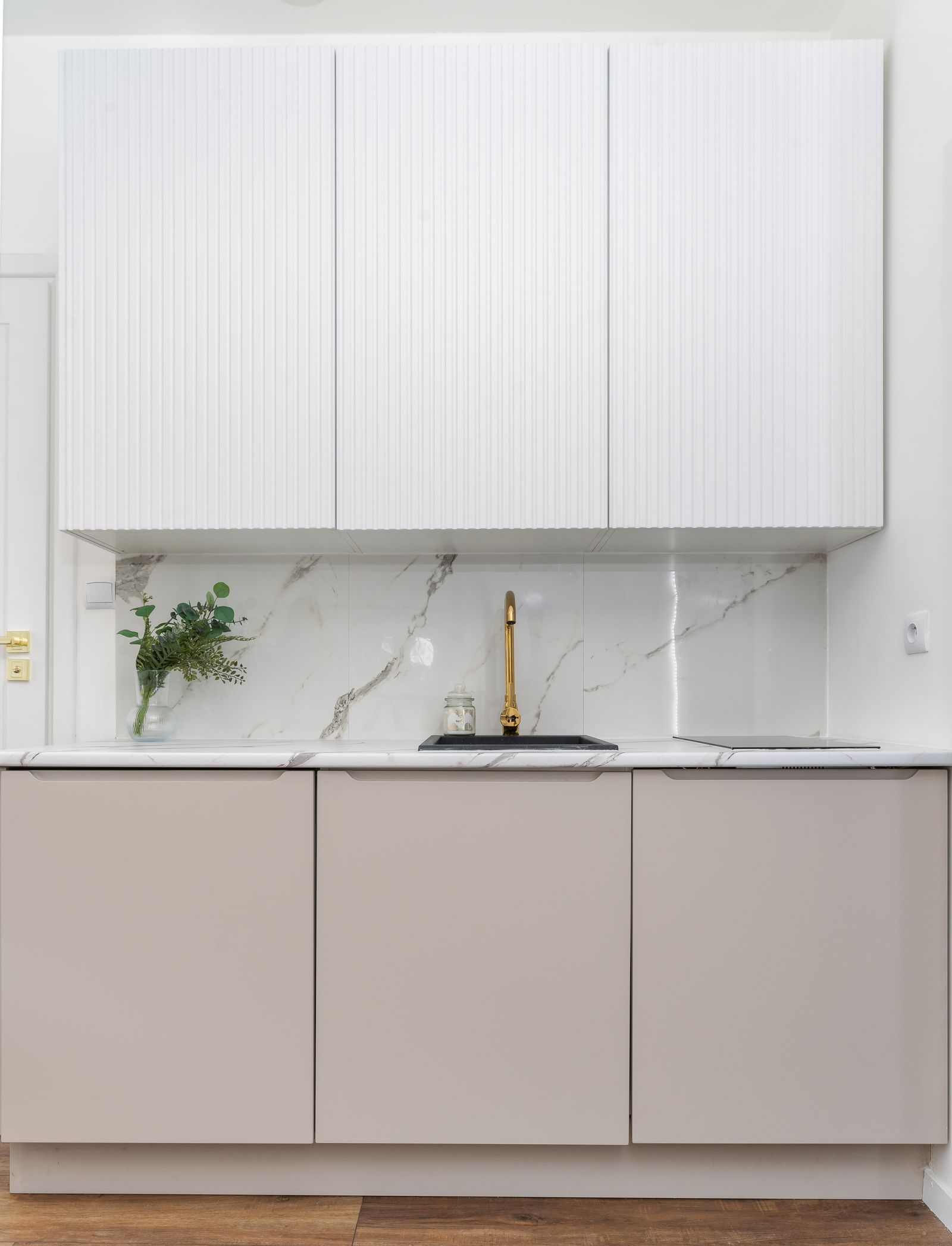 Minimalist luxury kitchen with marble backsplash and brass faucet — Arizona kitchen remodel
