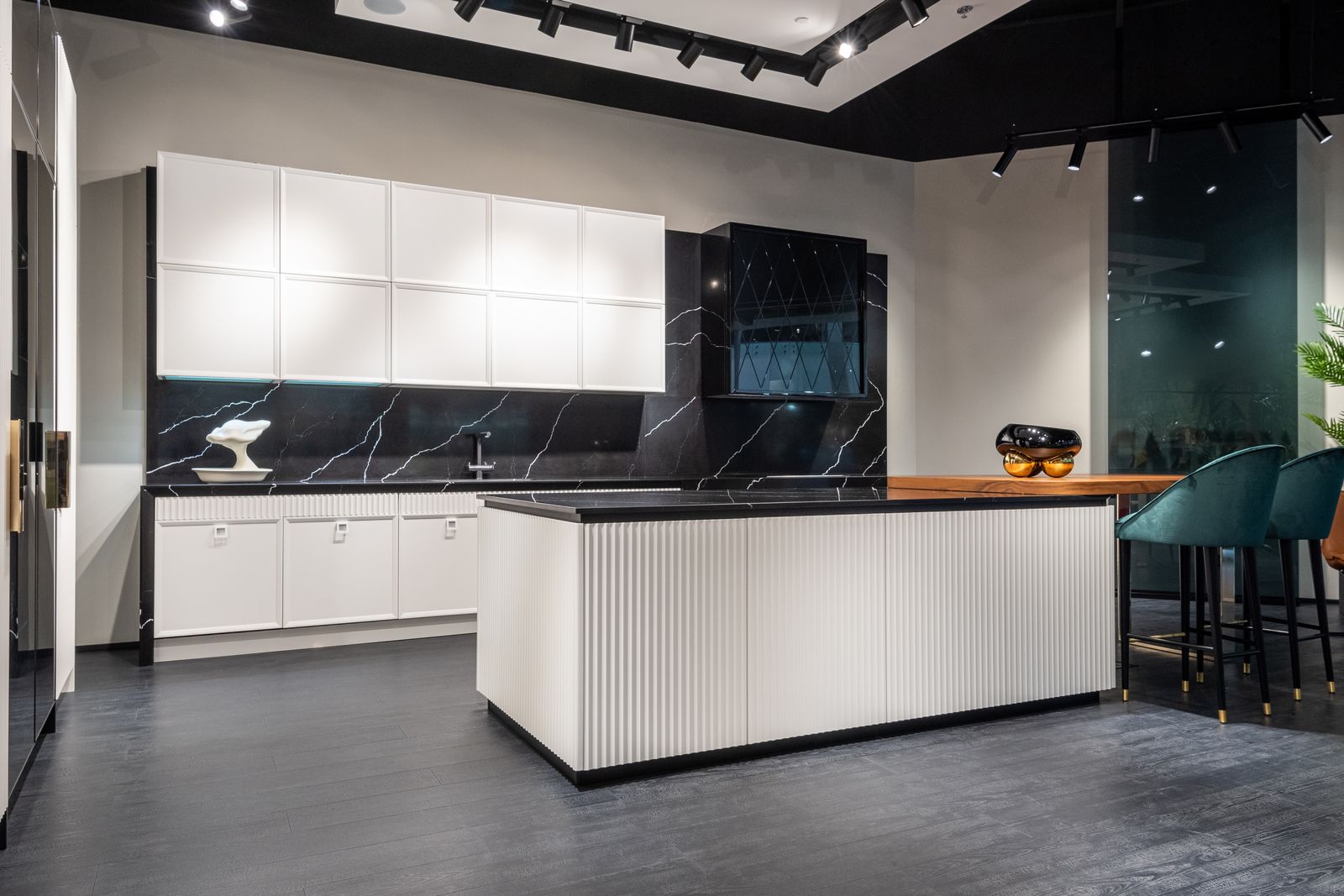 Modern kitchen with central island, white cabinets and black countertops