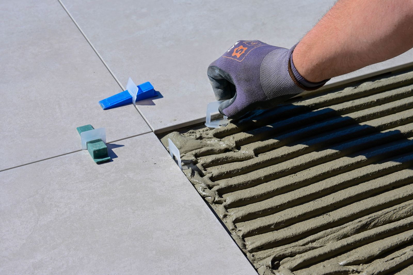 Tile setter installing tile — the craftsmanship behind an Arizona bathroom remodel